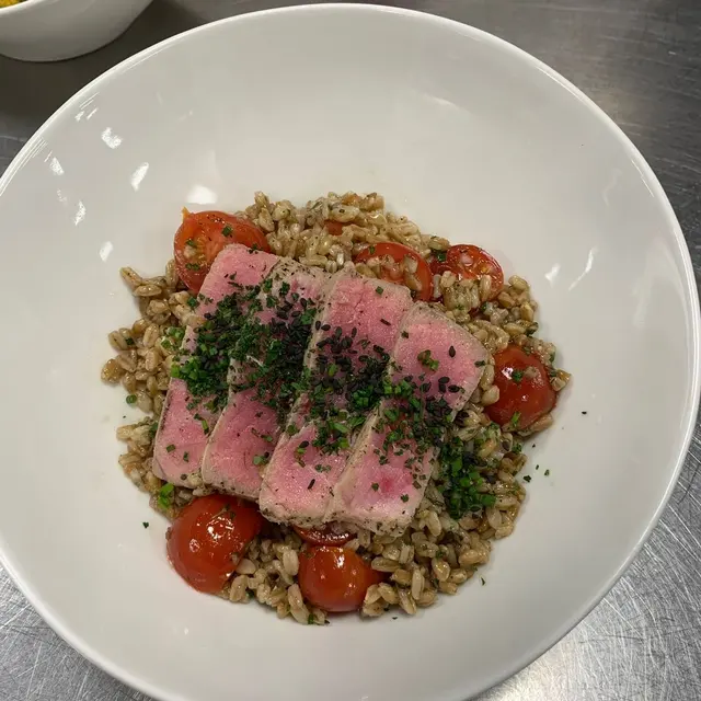 Seared ahi tuna over herbed farro with blistered tomatoes