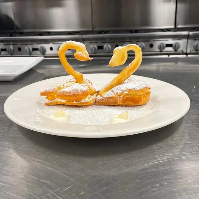Cream puff swans with chantilly and powdered sugar