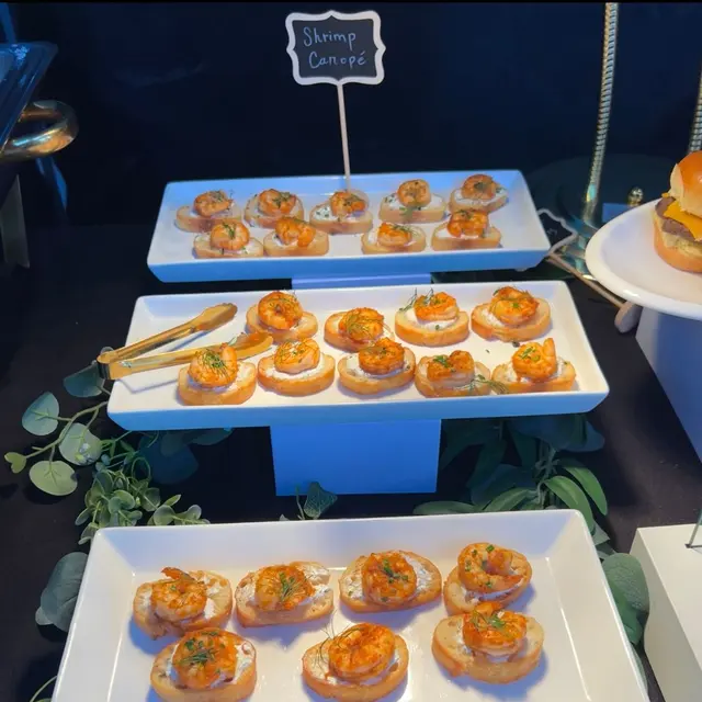 Shrimp canapés on tiered stands, styled with eucalyptus